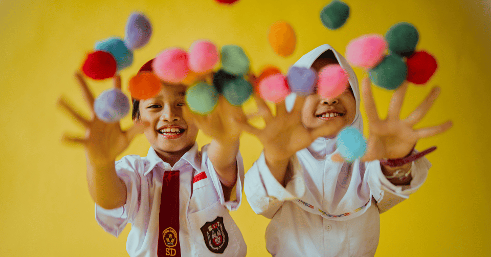 Children throwing colourful balls